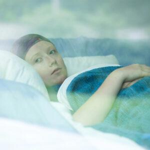 Female laying in hospice bed