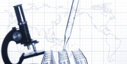 Glass test tubes and laboratory microscope on a world map .