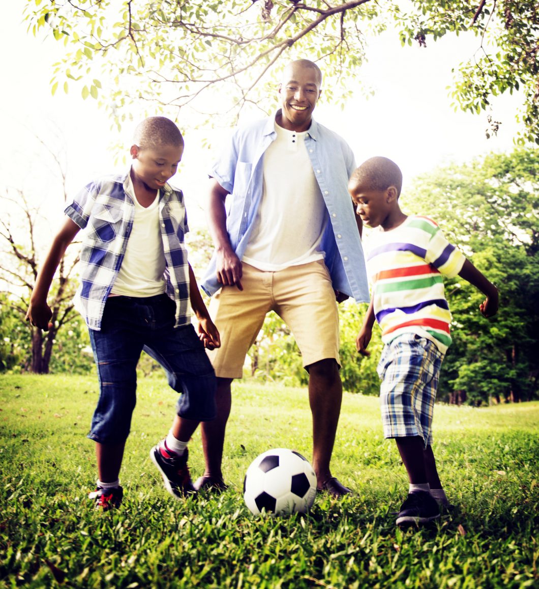 Father playing soccer with his sons - drug free
