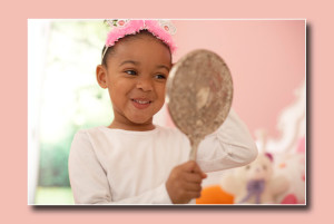 happy child looking in mirror